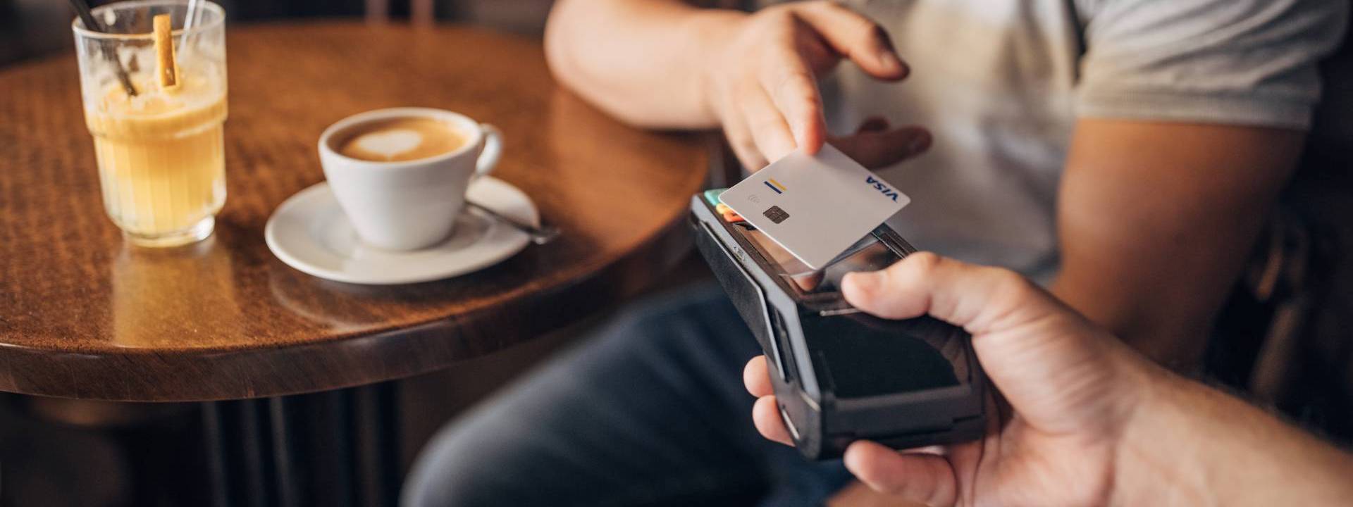 man paying contactless with mobile on a coffee shop